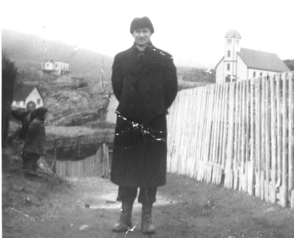 351: Fr. Haverstrow, a missionary, by J V McCarthy's fence. (circa 1949).